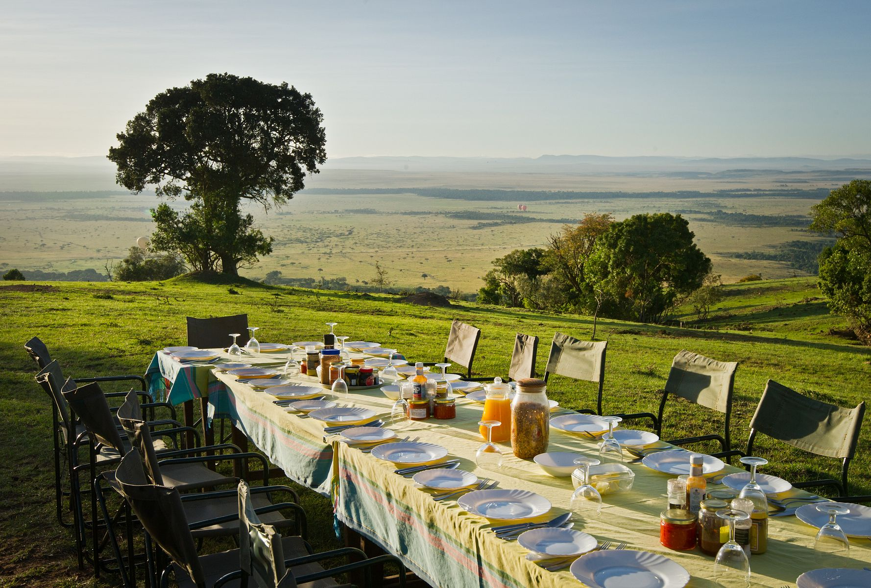 A long outdoor lunch table overlooking the Mara landscape